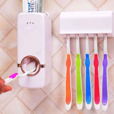 Toothpaste dispenser and tooth brush holder